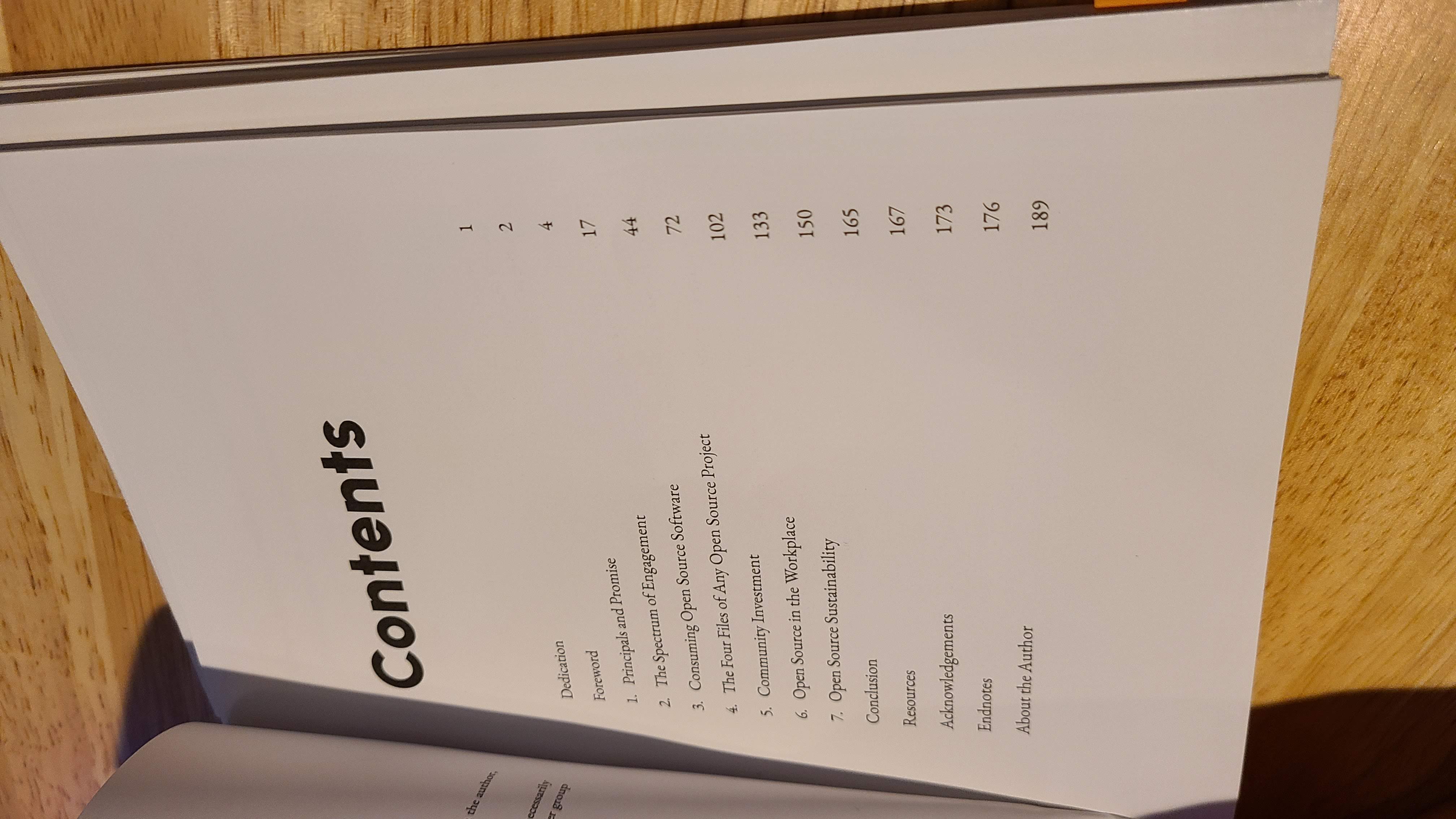 A photo of the table of contents within the proof of Approachable Open Source, unbound and already worn from a read-through!