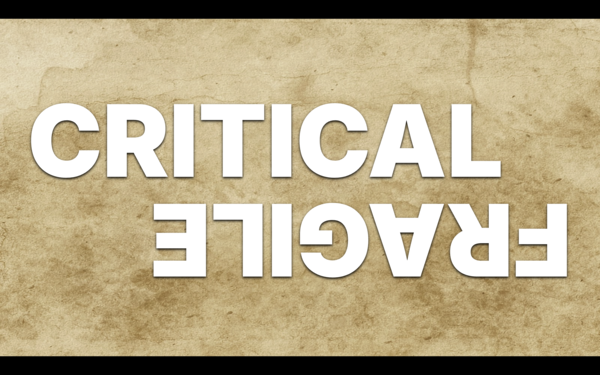 Two words in opposition in big block lettering. CRITICAL. And then upside down close to it, FRAGILE.
